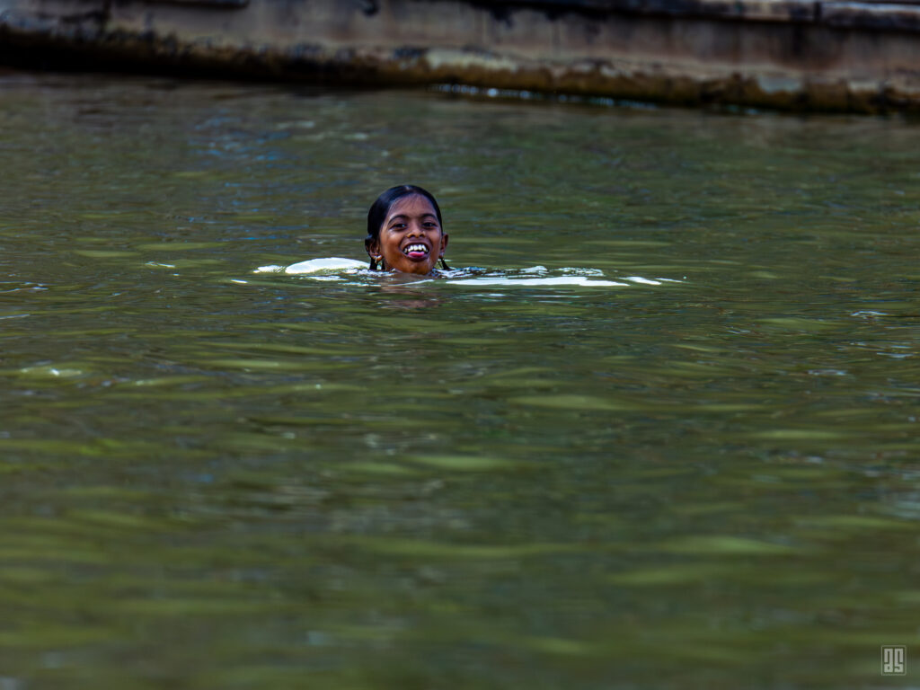 A young girl swimming in the water at Tanguar Haor, Sunamganj, Bangladesh. Photo by Jaman | AsadSnapper.