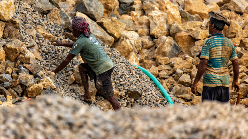 Labourers working among piles of stone at the Jadukata River in Sunamganj, Bangladesh. Photo by Jaman | AsadSnapper.